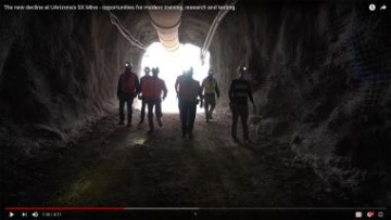 screenshot of a video of people walking out of a mine